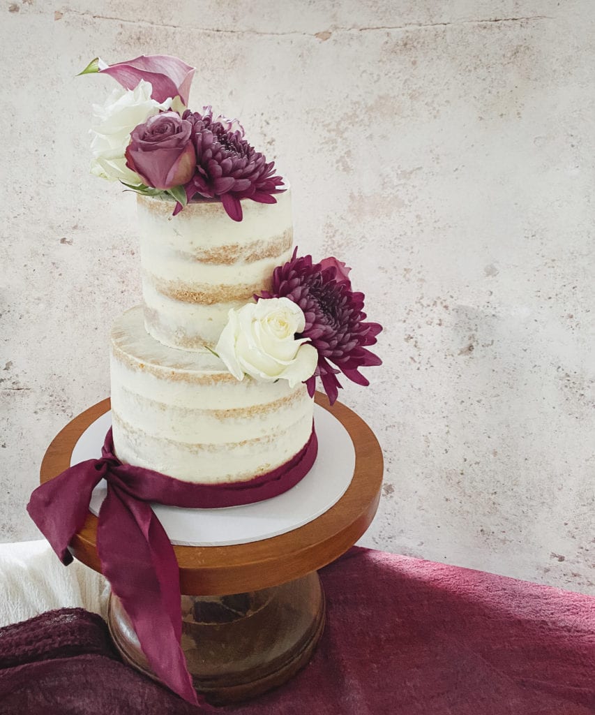 Luxury semi naked wedding cake with sugar flowers by Layers and Graces bespoke wedding cakes Hertfordshire Essex London